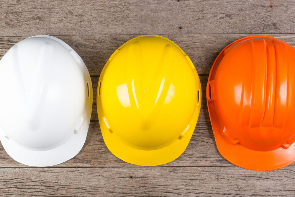 Three Construction Workers Safety Helmets