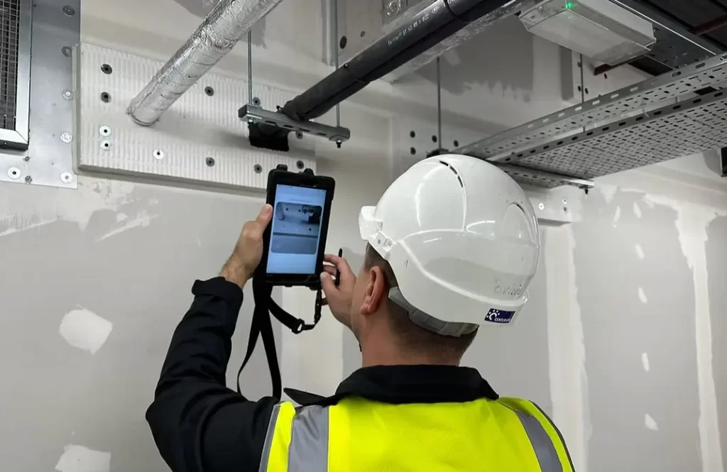 Certified technician inspecting and maintaining a commercial fire door during a fire safety training course